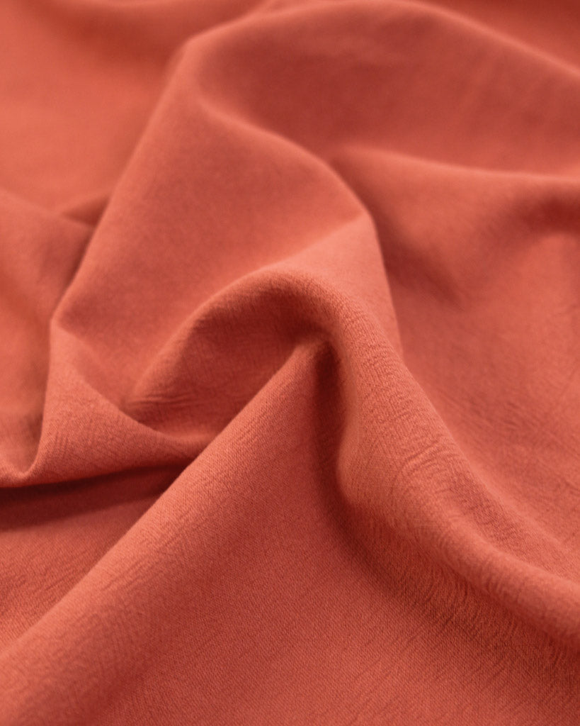 crushed washed cotton fabric in hot red-orange