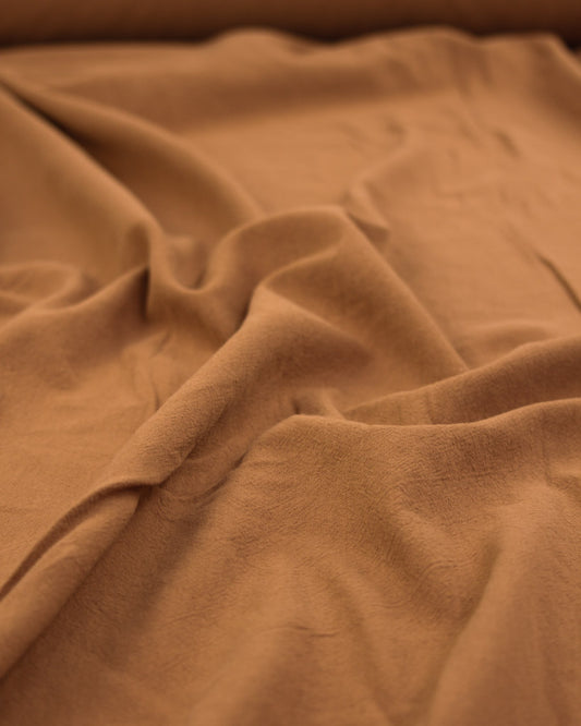 Crushed washed cotton fabric in ginger brown