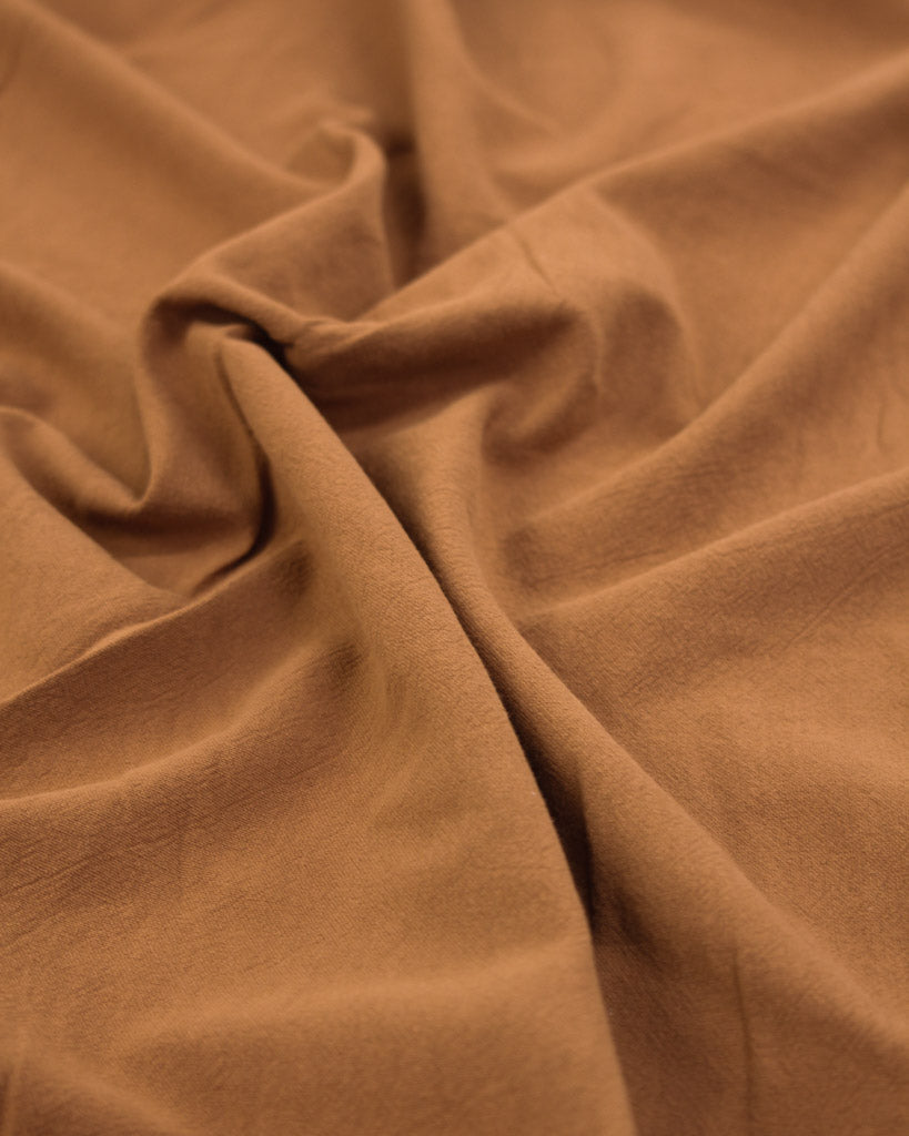 Crushed washed cotton fabric in ginger brown