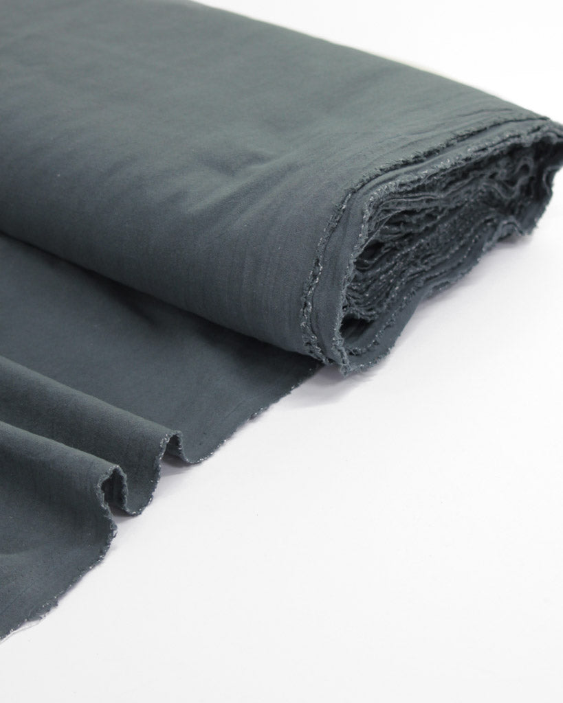 Bolt of crushed washed cotton fabric in slate grey