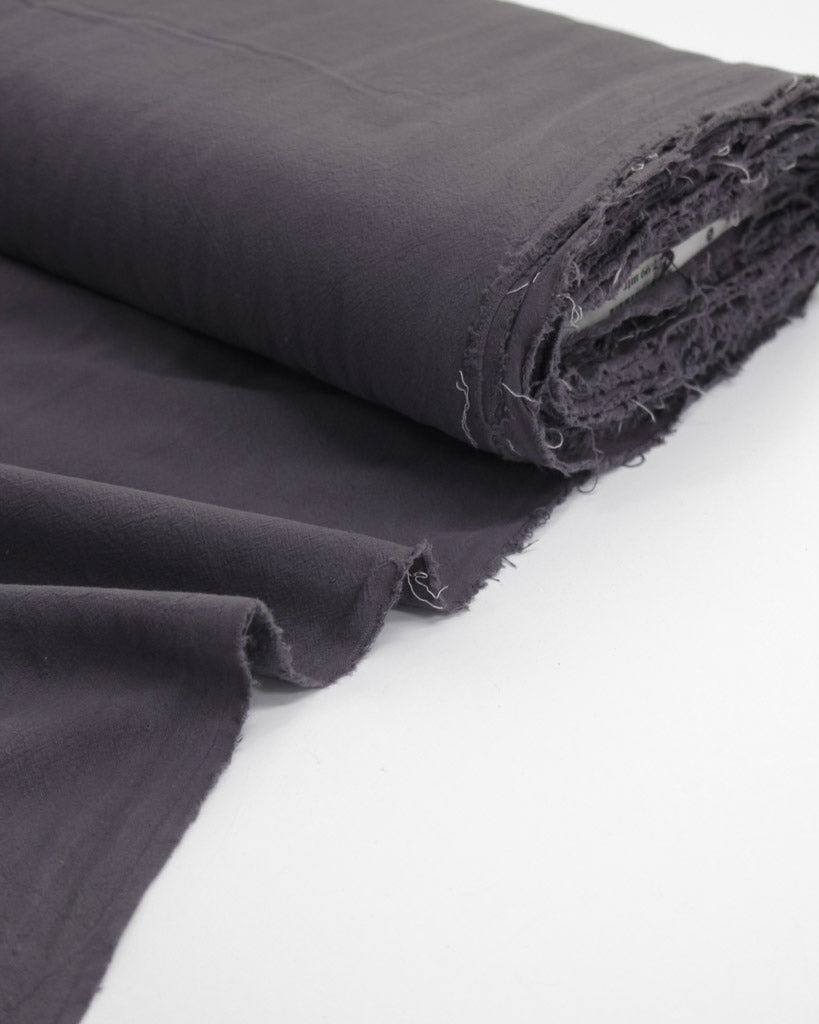 Bolt of crushed washed cotton fabric in dark grey