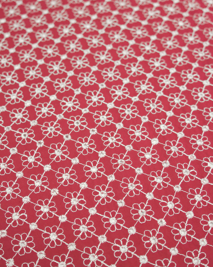 Red cotton broderie anglais fabric with white floral eyelet embroidery