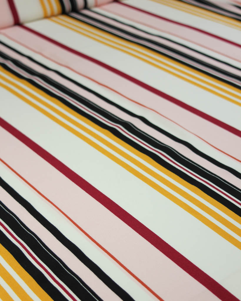 Striped viscose crepe fabric with multicolor pattern on a white background
