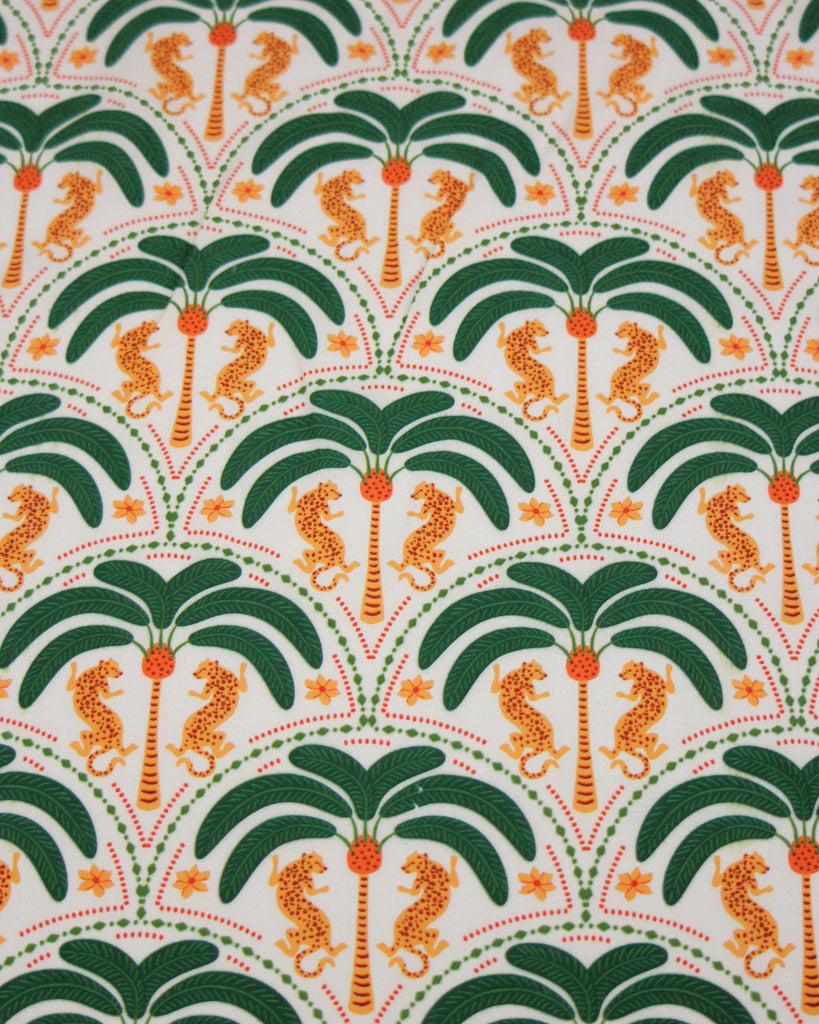 Viscose fabric with pattern of palm trees and leopards on a green background
