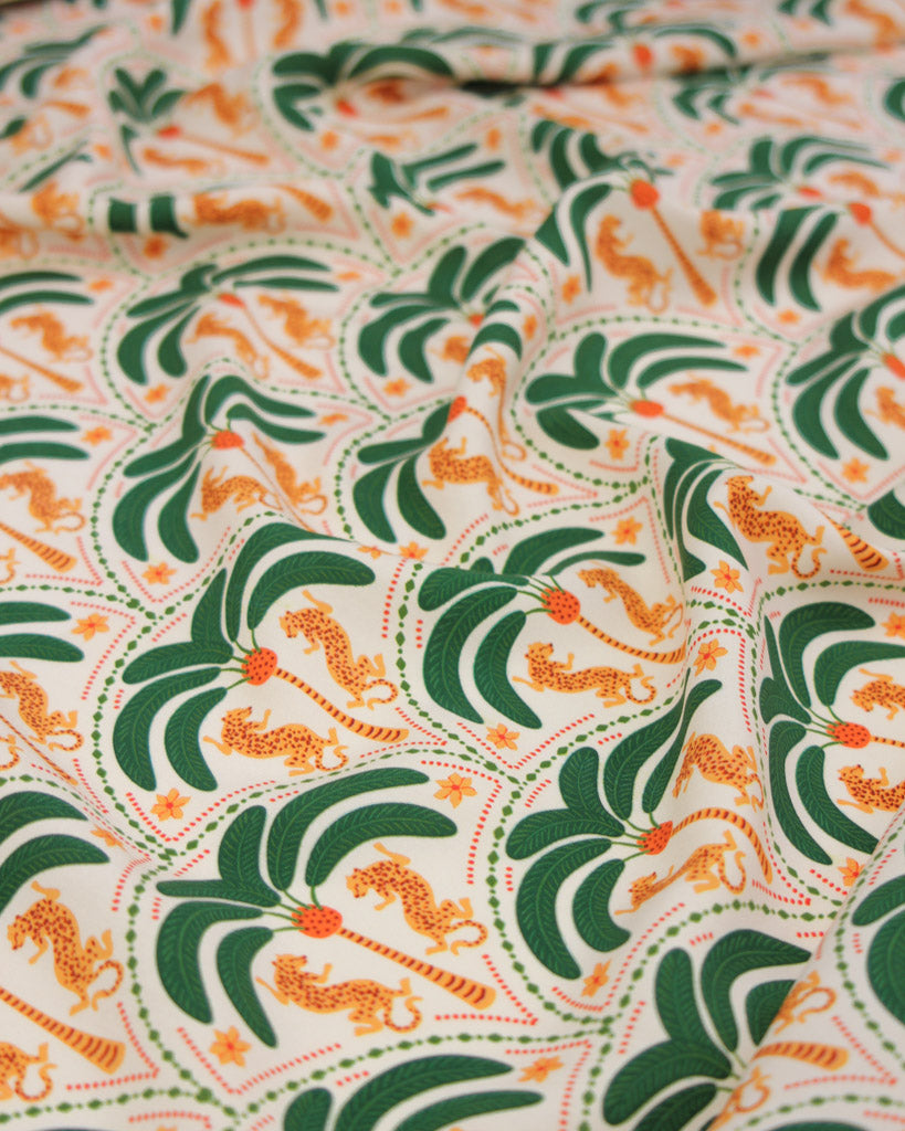 Soft viscose fabric with a pattern of green palm trees and leopards