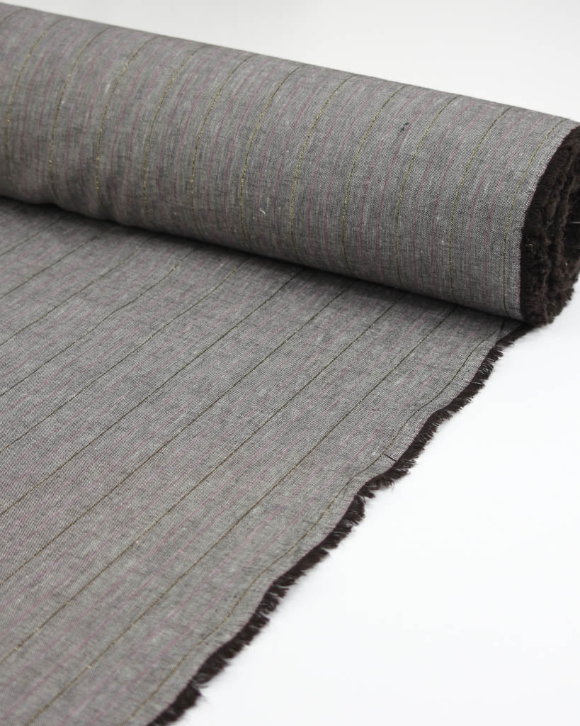 Roll of grey linen and viscose fabric with a subtle stripe of metallic gold lurex