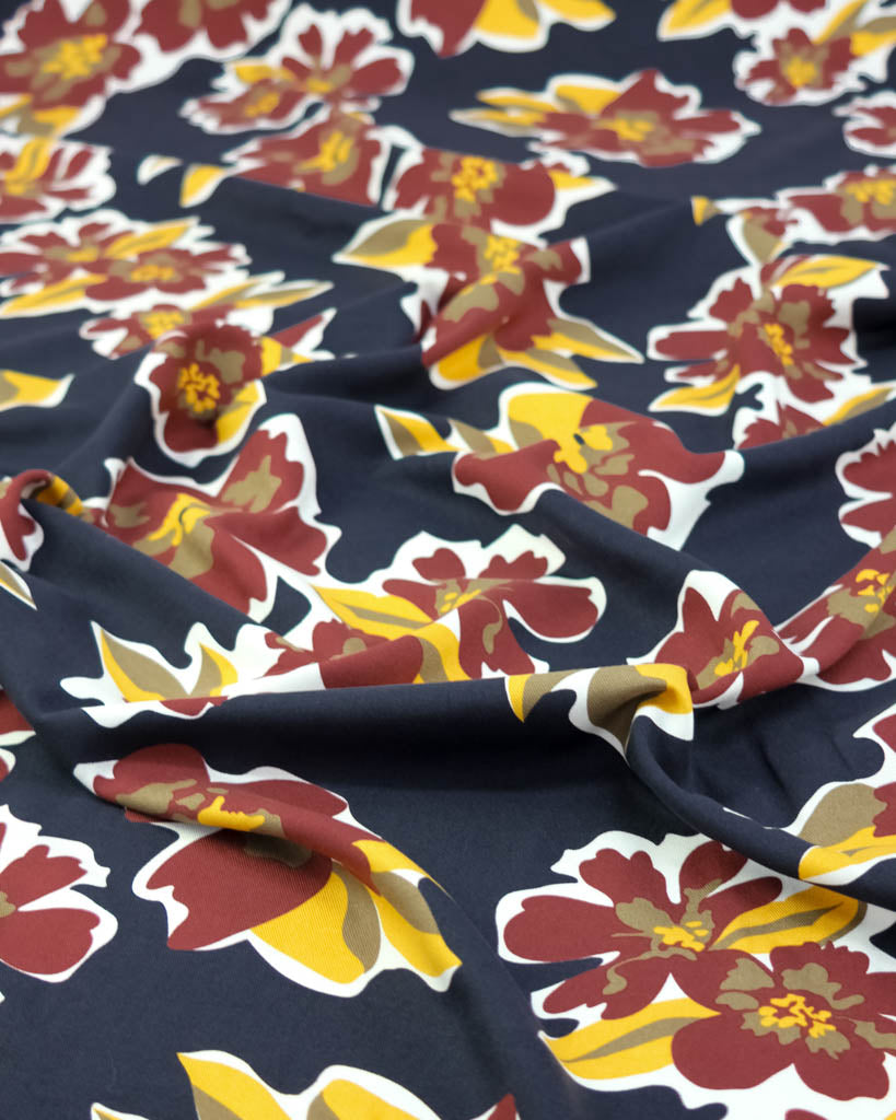 Floral fabric viscose pattern with red, yellow, and white flowers on a navy background