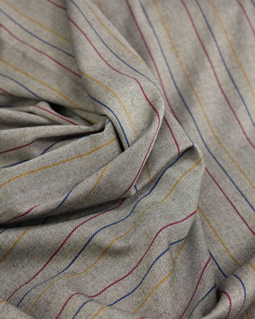 Close-up of beige poly viscose fabric with multicolored stripes