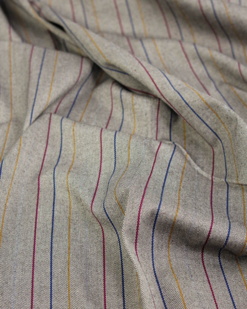 Close-up of poly viscose fabric with multicolored stripes on a neutral background