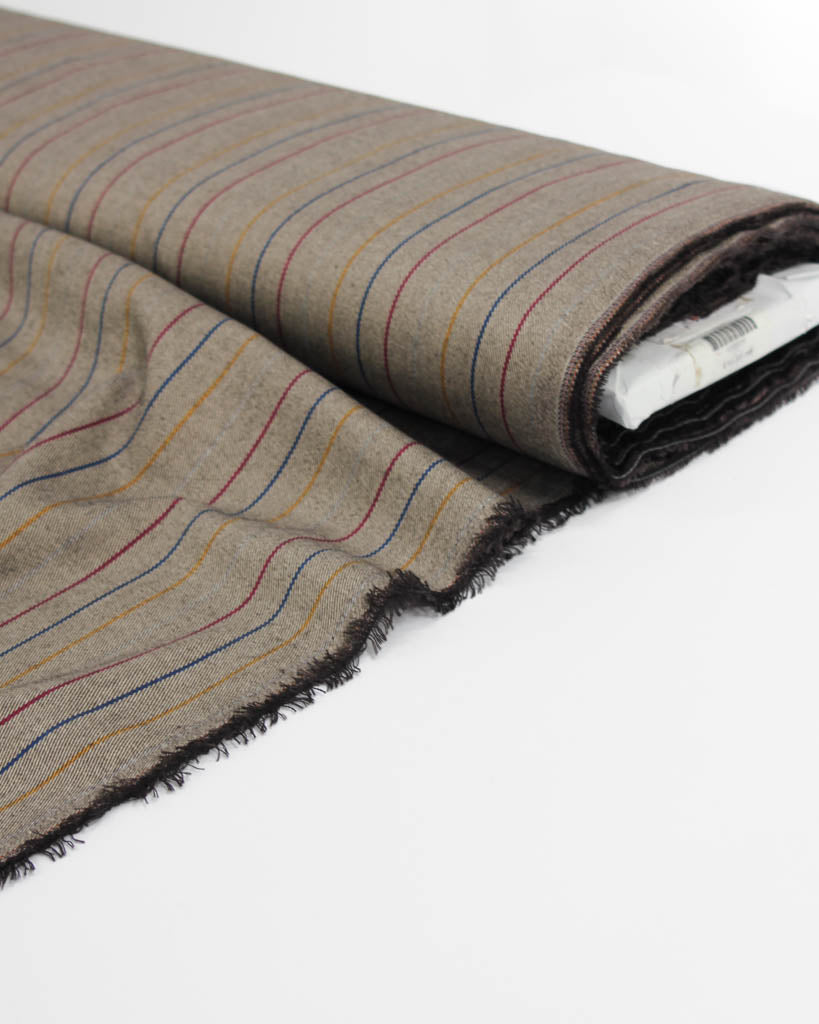 Roll of poly viscose fabric with multicolored stripes on a white background