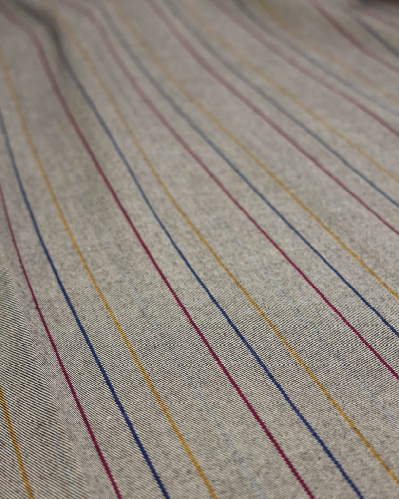 Close-up of poly viscose fabric with multicolored stripes on a neutral background