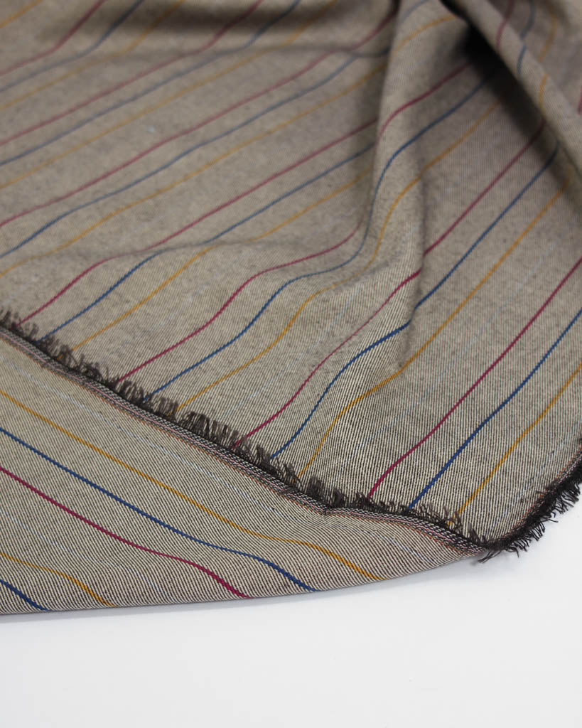 Close-up of poly viscose fabric with multicolored stripes on a neutral background