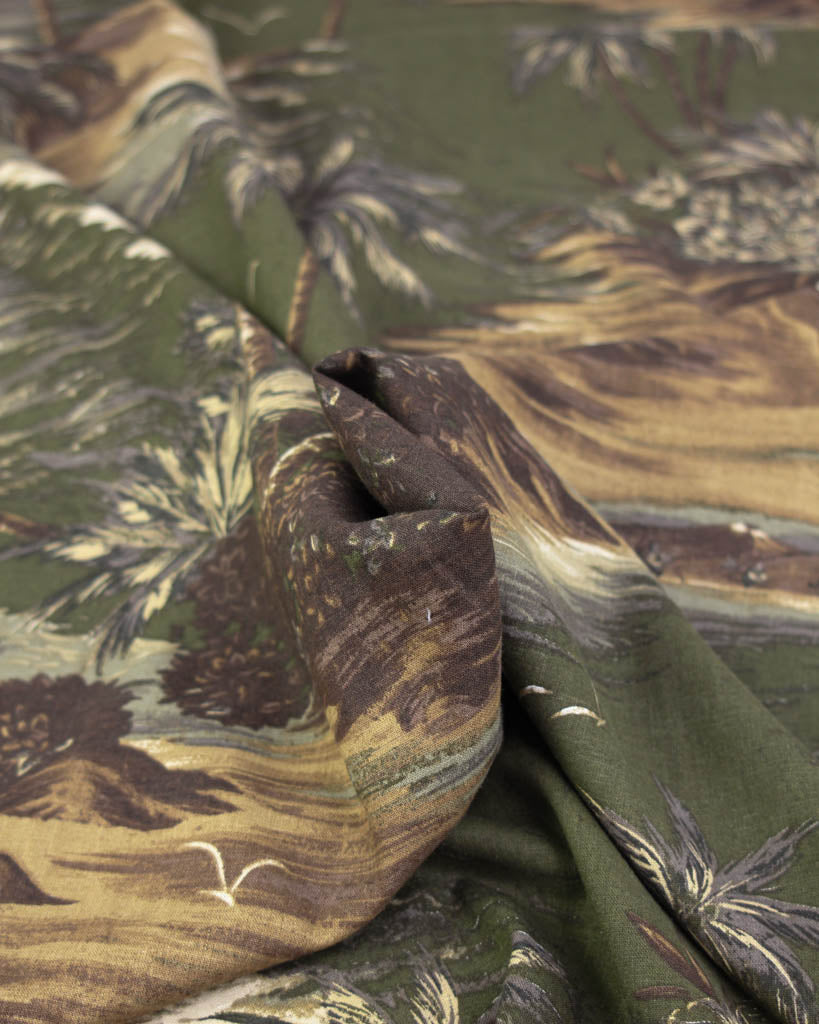 Close-up of a linen viscose fabric with tropical pattern featuring palm trees and plants.