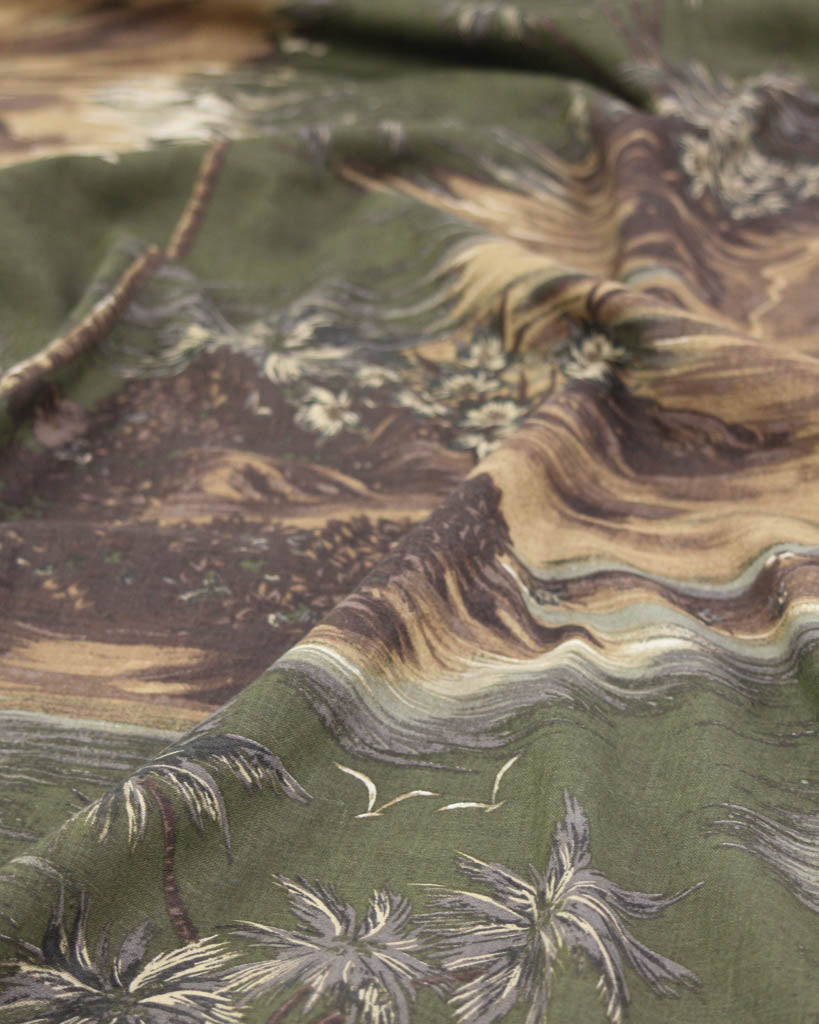Close-up of a green linen viscose fabric with a palm tree landscape 