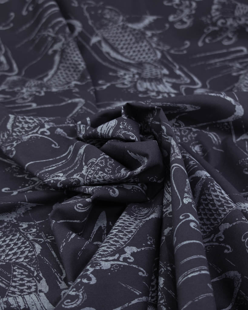 Close-up of dark blue linen cotton fabric with a koi fish pattern