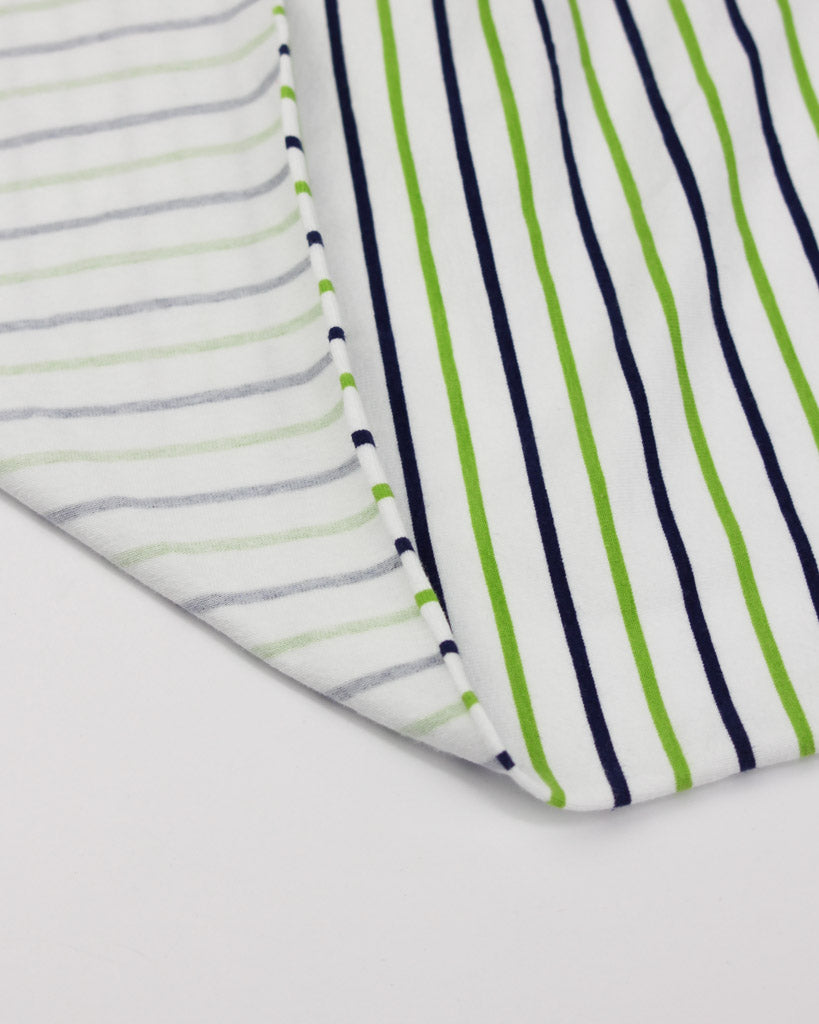 Close-up of striped cotton jersey fabric with green, blue, and gray lines on a white background