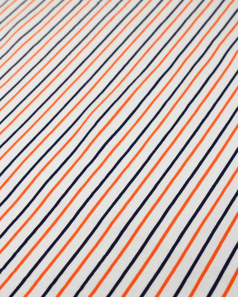 Striped pattern cotton jersey fabric with orange and navy lines on a white background