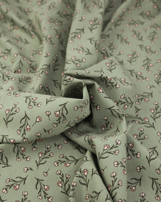 Green jersey knit fabric with small floral pattern