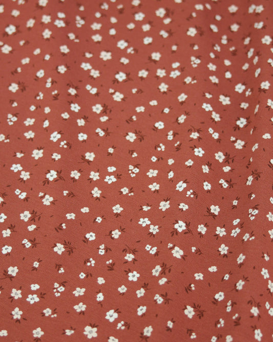 Red cotton jersey fabric with small white floral pattern