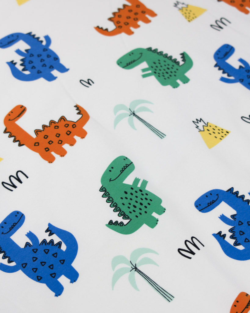 Pattern of colourful cartoon dinosaurs and palm trees on a white background on cotton jersey fabric 