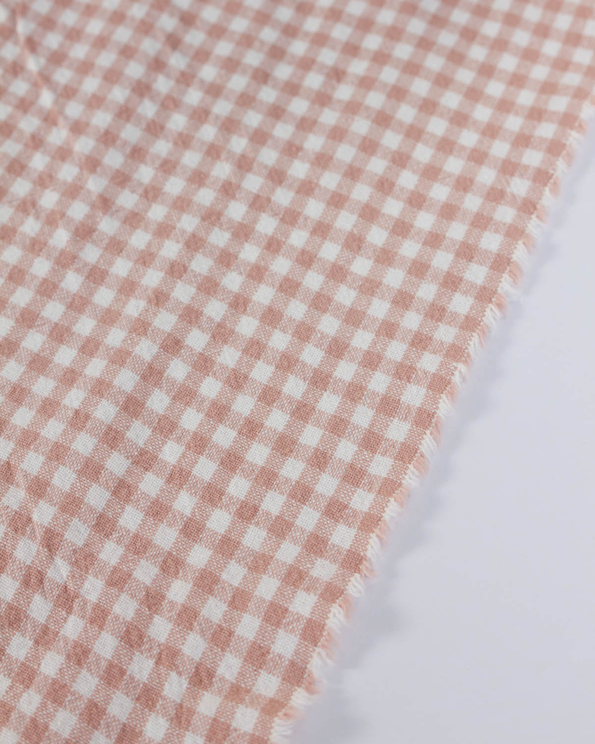 Close-up of a pink and white checkered gingham organic cotton fabric