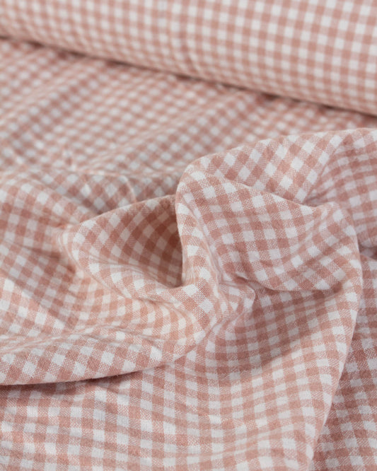 Close-up of pink and white checkered gingham organic cotton fabric