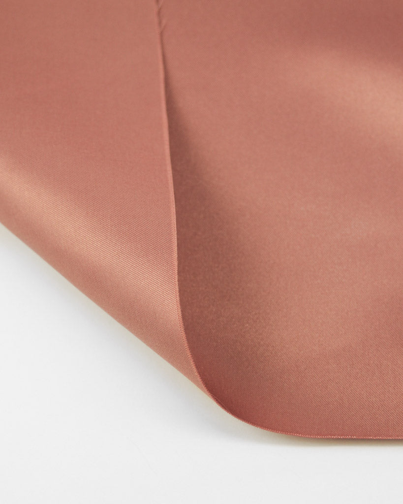 Close-up of a pink satin  fabric on a white background