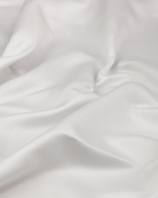 Close-up of white duchess satin fabric with subtle texture