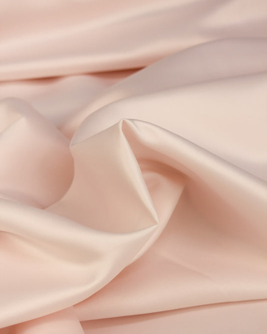 Close up of pale pink duchess satin fabric