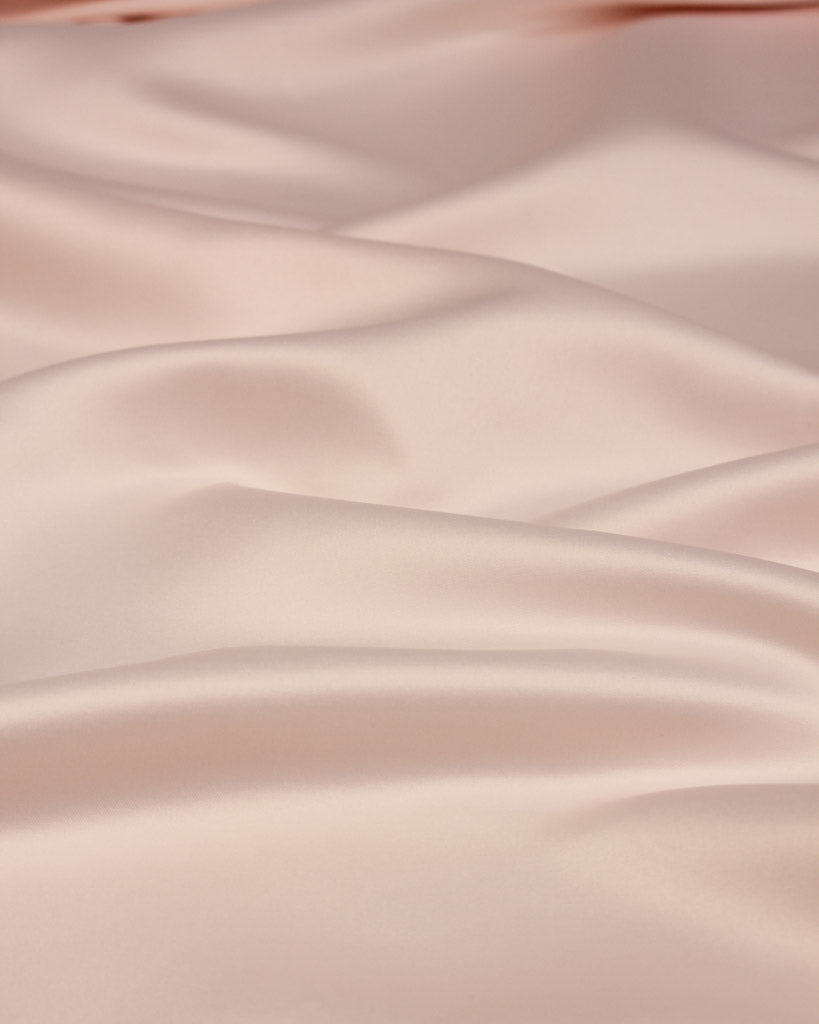 Close-up of smooth, light pink satin fabric