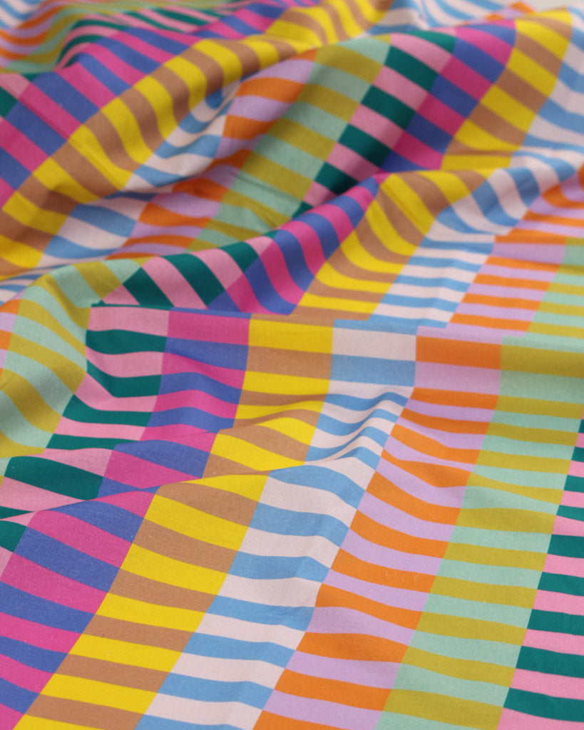 Colourful striped cotton fabric with a pattern of multicoloured lines.