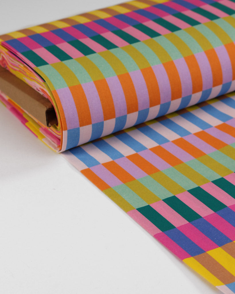 Roll of colourful checkered cotton fabric with multi coloured stripes
