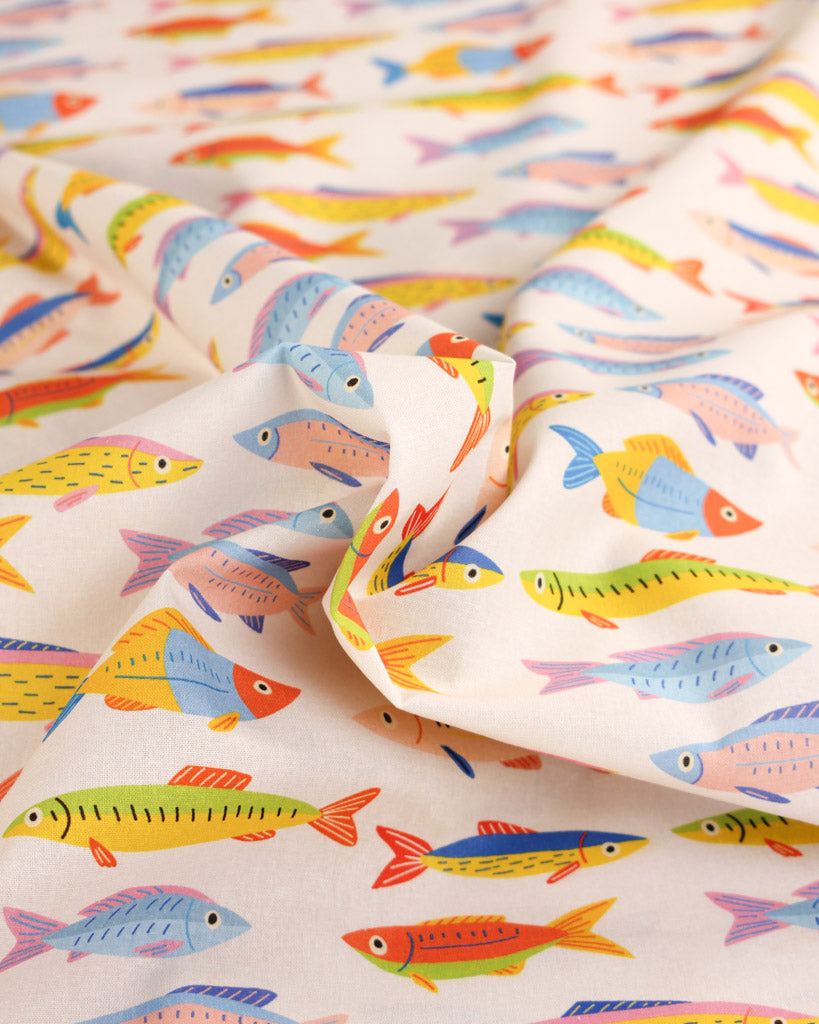 Colourful fish repeat pattern on white cotton fabric