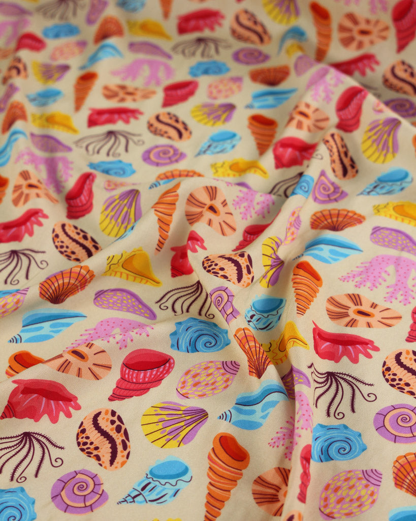 Colourful drapey viscose fabric with beach shell pattern