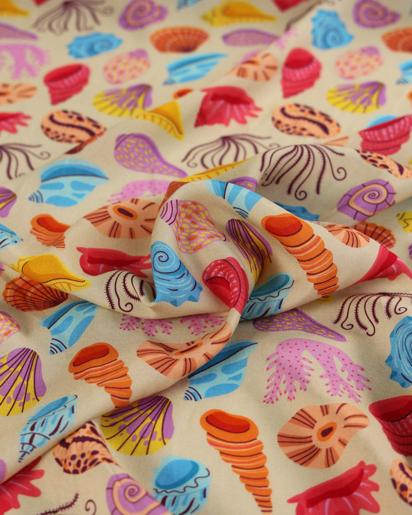 Colorful fabric with shell pattern on a beige background