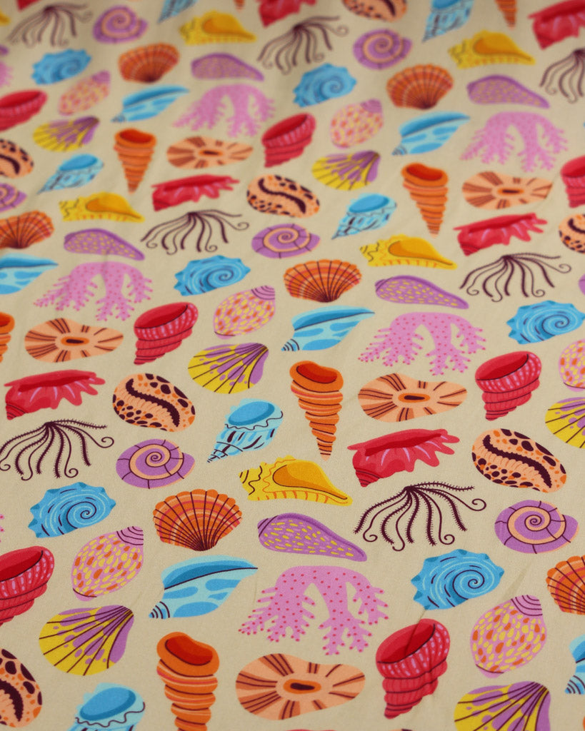 Viscose fabric with a colorful pattern of sea shells and coral on a beige background