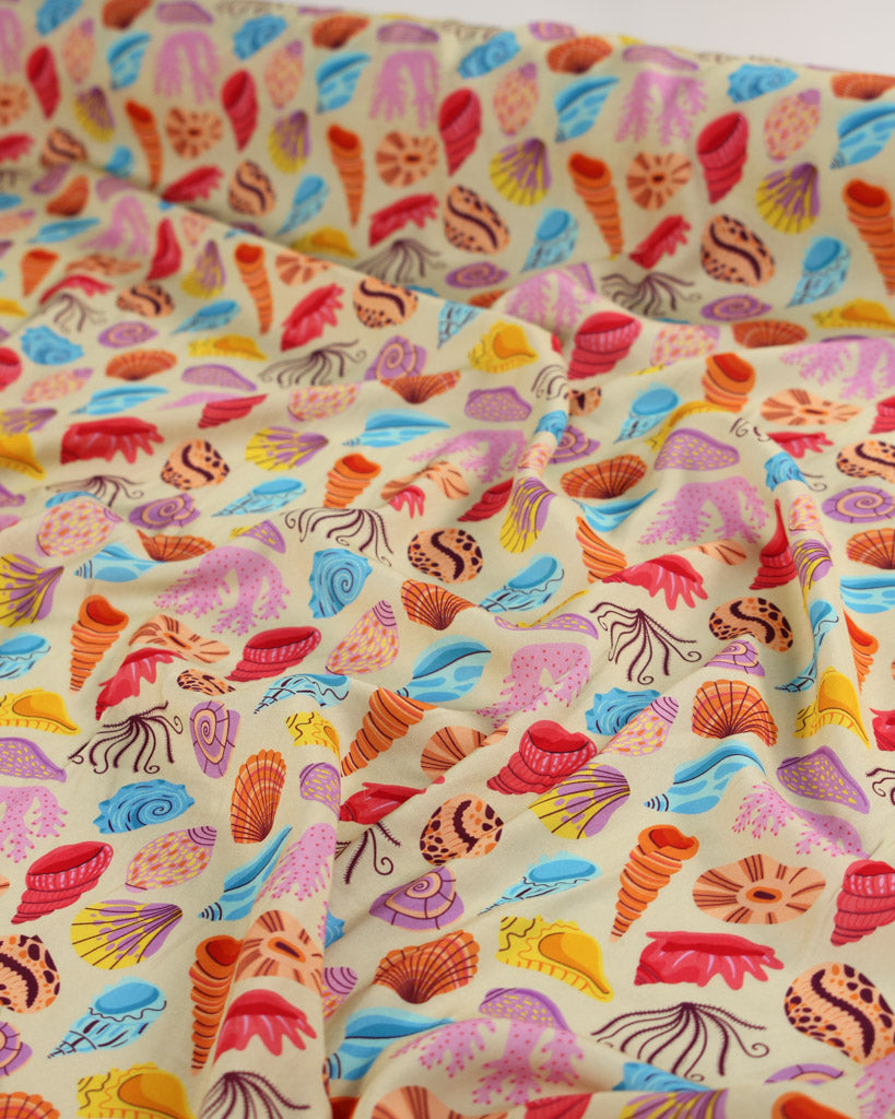 Colorful viscose fabric with shell pattern on a beige background