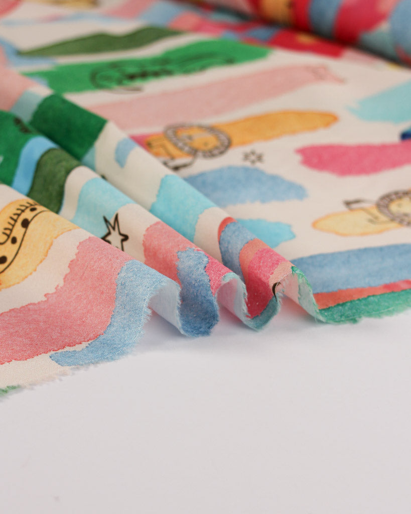 Colourful cotton lawn fabric with cartoon animal characters and patterns on a white background