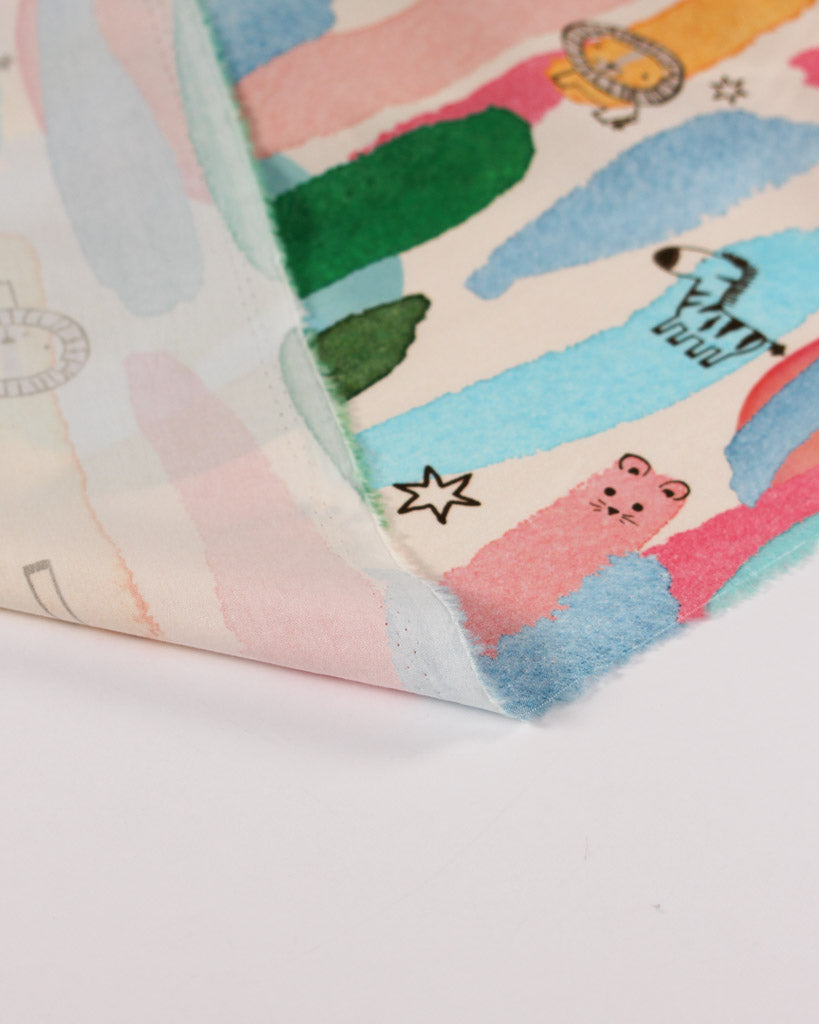 Colorful cotton lawn fabric with cartoon animal designs on a white background