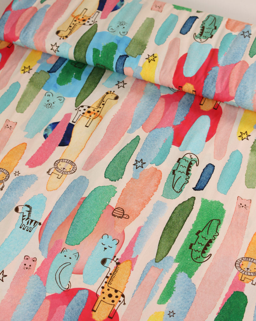 Colourful cotton lawn fabric with cartoon animal patterns on a light background