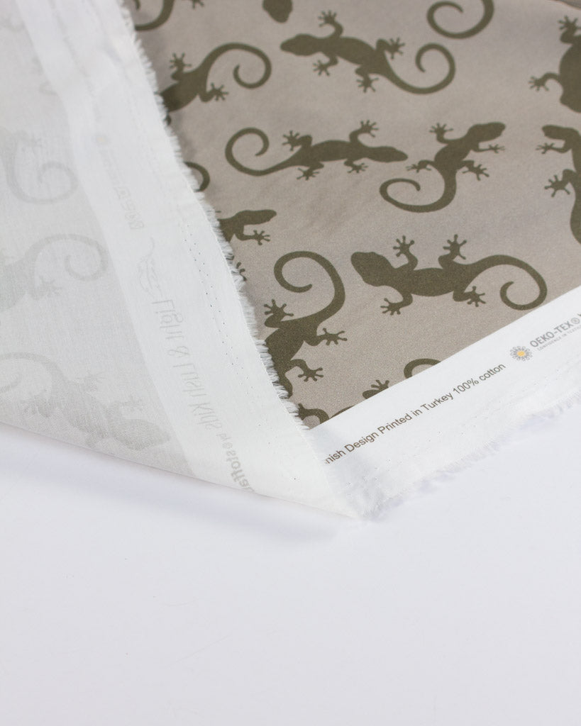 Cotton lawn fabric with lizard pattern on a beige background