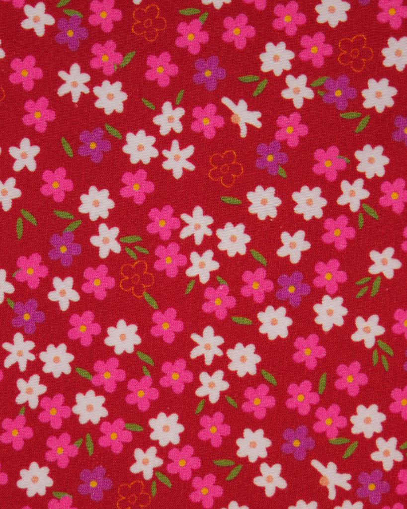 Floral pattern with pink, white, and purple flowers on a red background on cotton jersey fabric