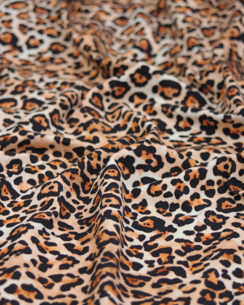 Leopard print cotton jersey fabric with a close-up view