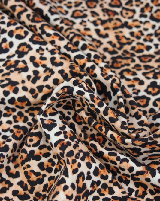 Leopard print cotton jersey fabric with a close-up view