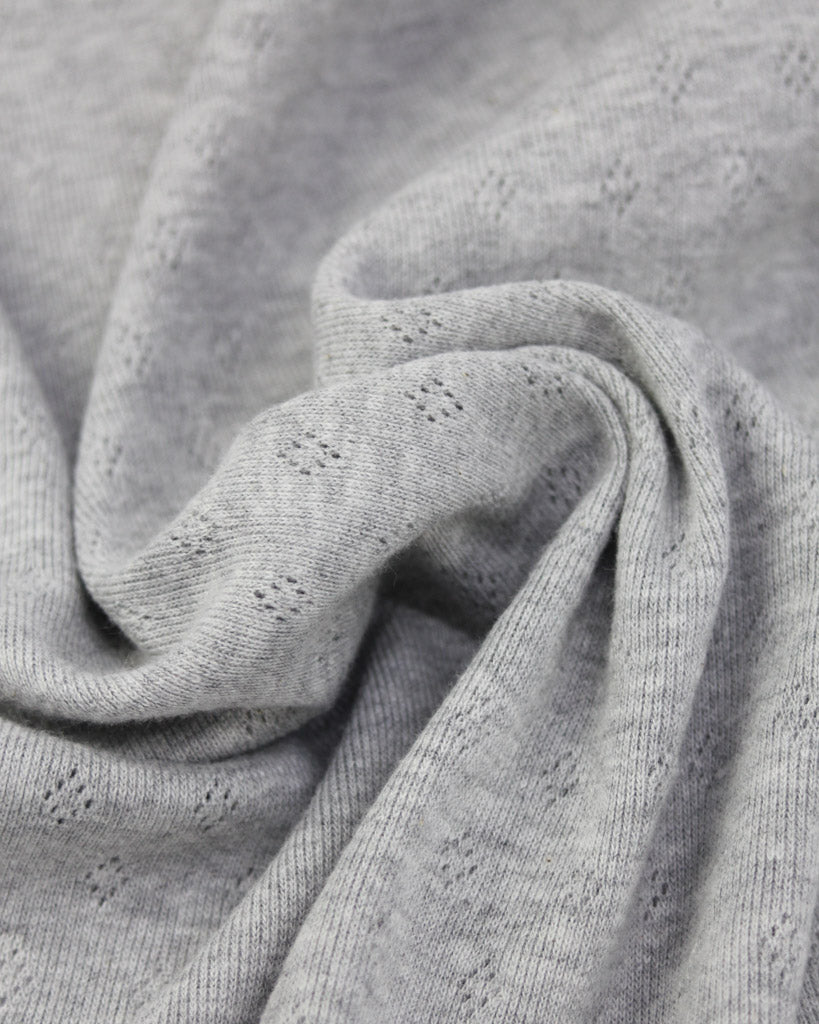 Close-up of grey pointelle knit textured fabric