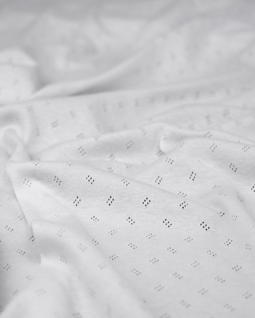 White pointelle fabric with a subtle pattern