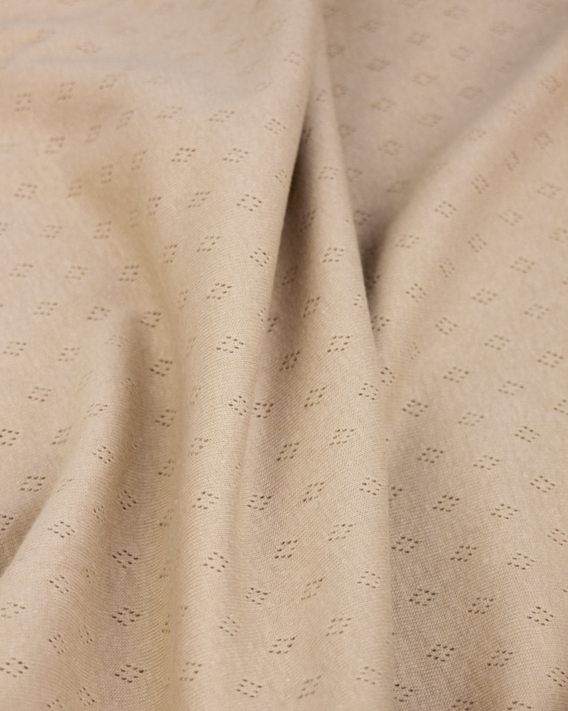 Beige pointelle fabric with subtle pattern