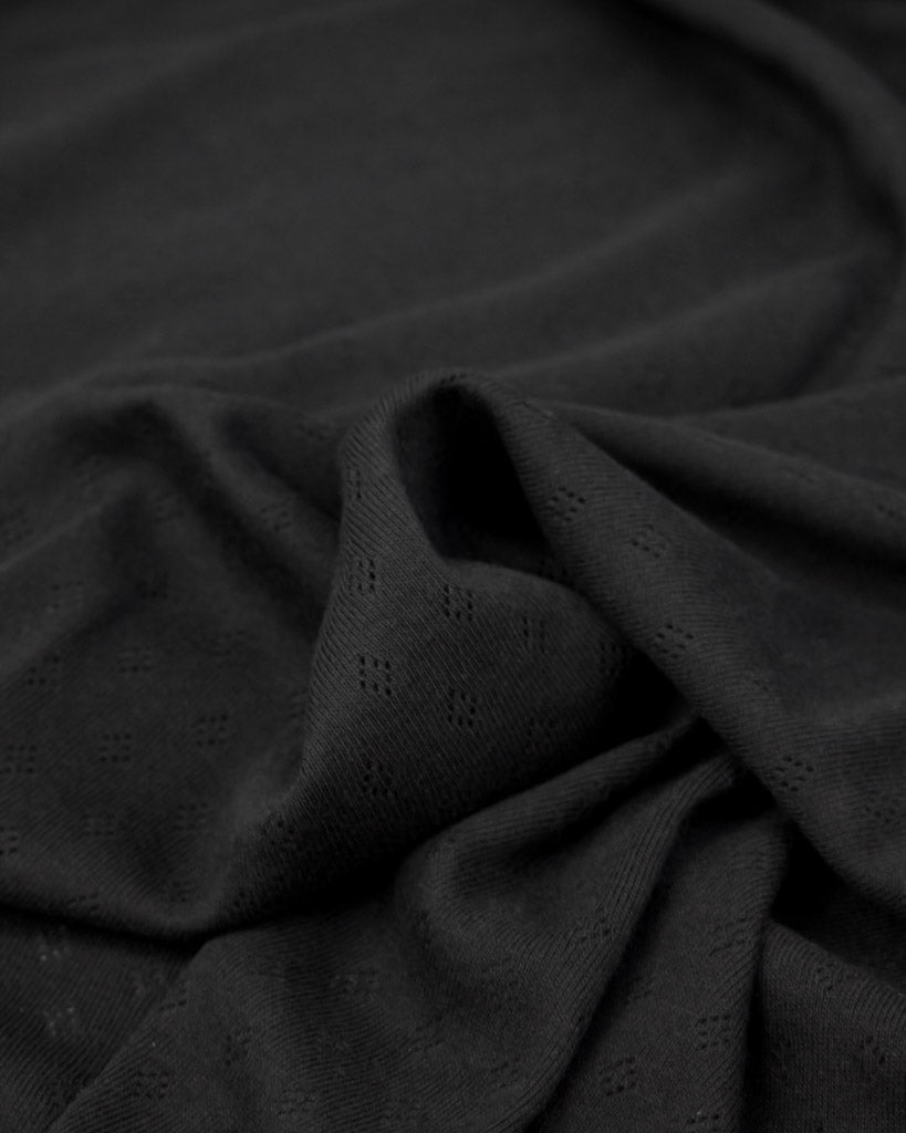 Black fabric pointelle jersey fabric with small diamond hole patterns