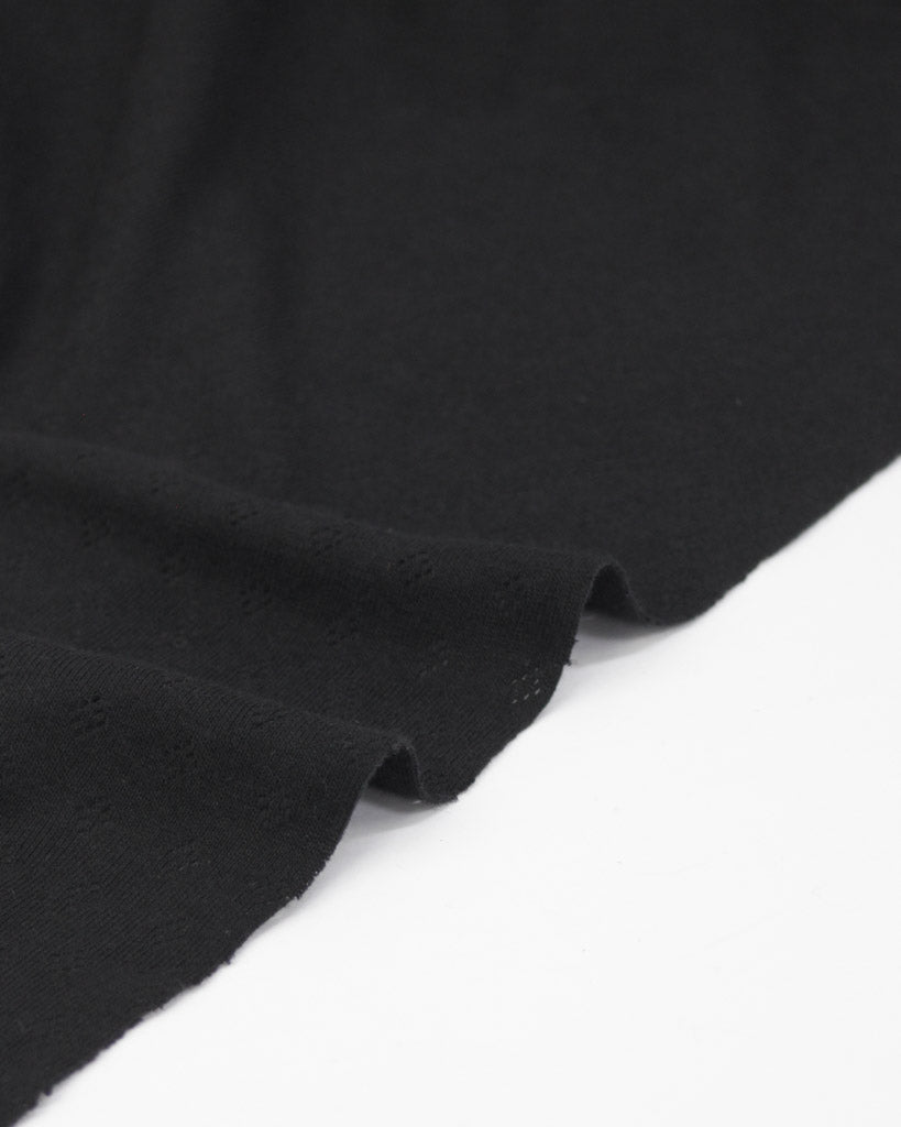 Black fabric pointelle jersey fabric with small diamond hole patterns