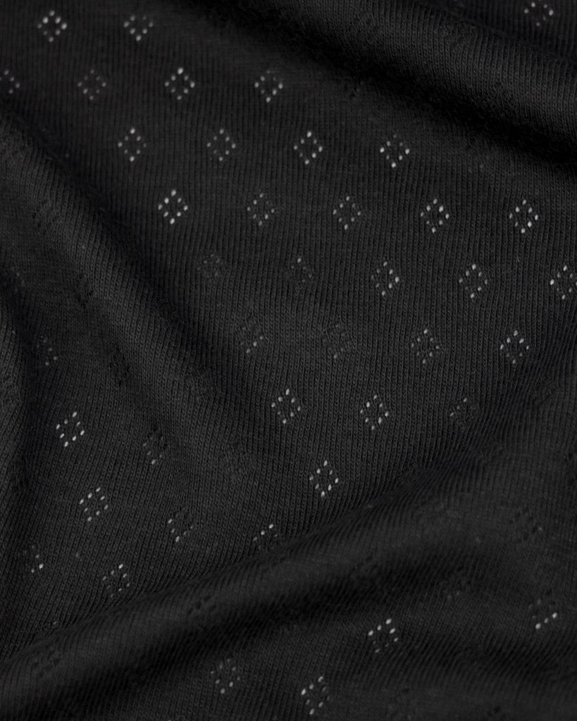 Black fabric pointelle jersey fabric with small diamond hole patterns